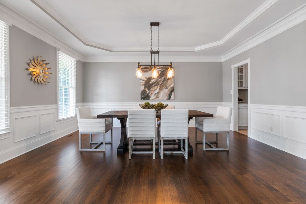 A Crescentwood dining room with panelled wainscoting over a dark-stained hardwood floor.