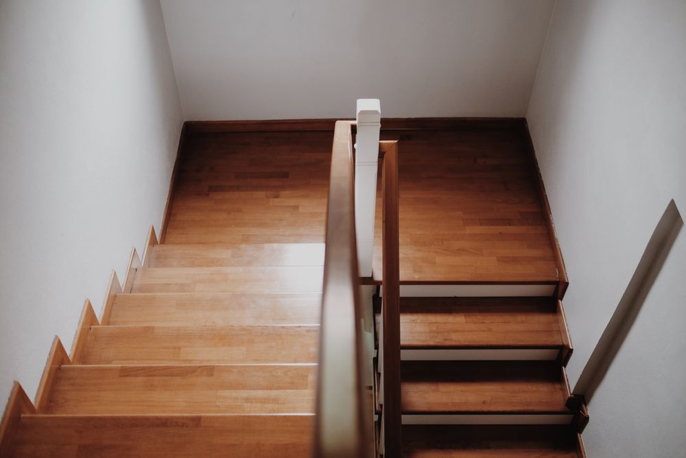 Light oak stairs and a landing in a modest older St. Boniface house.
